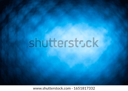 Bright abstract deep blue image for background. photo through glass with a pattern. high resolution image. vignetting