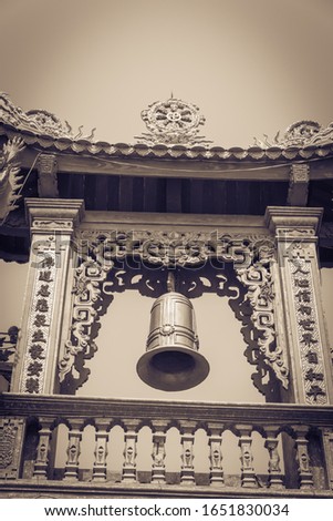 Toned photo typical bell tower outdoor instrument, ancient bell and gazebo in the pagoda in Vietnam