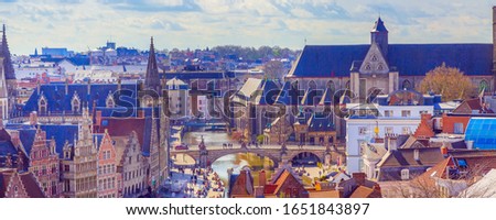 Aerial panoramic banner cityscape view of Ghent, Belgium with St. Michael Bridge and church and canal