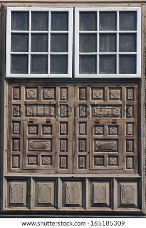 brown double wooden door with carvings