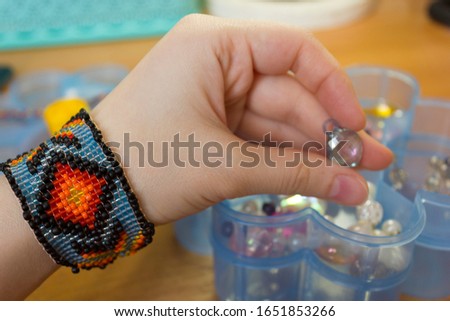 needlework. woven bracelets from ribbons, woven bracelets from beads. needlework accessories,hobby needlework