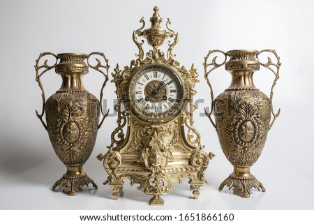 bronze amphorae and clock on a white background, antique vases and clock studio photo, antique clock and two antique vessels,  Royalty-Free Stock Photo #1651866160