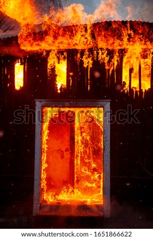 Burning house in forest fire