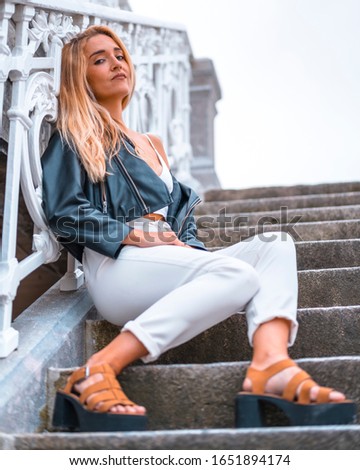 Lifestyle, young caucasian blonde sitting on some stairs