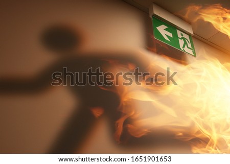 the shadow of an escaping man and a fire in the building