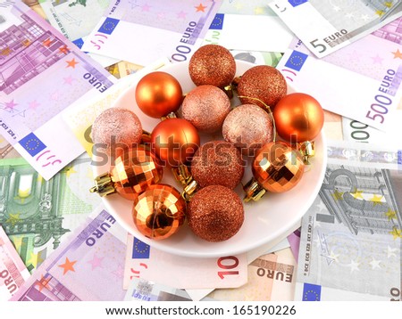 Christmas balls set on white plate, dollar background