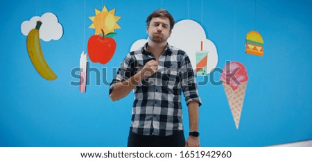 Medium shot of a man expressing love for unhealthy fast food