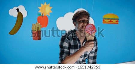 Medium shot of a man expressing love for unhealthy fast food
