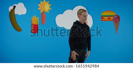Medium shot of a boy longing for unhealthy fast food