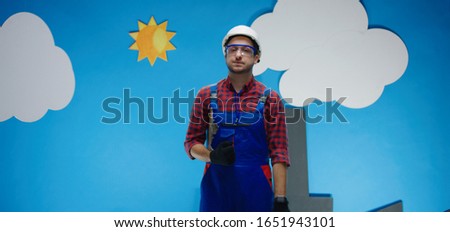 Medium shot of a technician in hard hat walking and worrying about the time