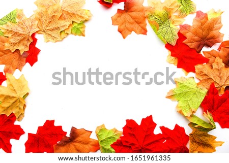 round frame of autumn leaves with white background. 