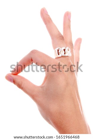 Woman hand is making okay sign with fingers over white background