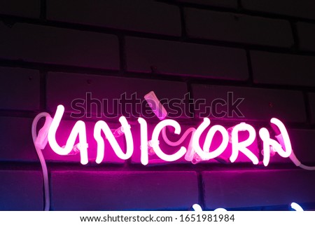 neon sign with words unicorn, purple neon retro inscription. Sign for night show in club. concept of galaxy space