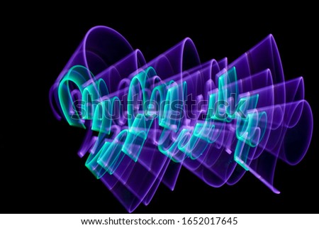 Curved abstract shape made with a light saber violet. Lightpainting session at night. Leds light effect. Background for wallpaper.