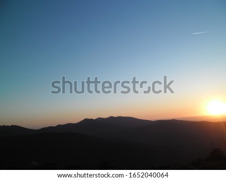 Photograph of some mountains in sunset