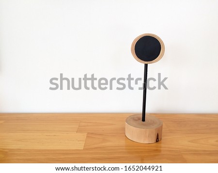 Blank sign of table number put on wooden table with white background