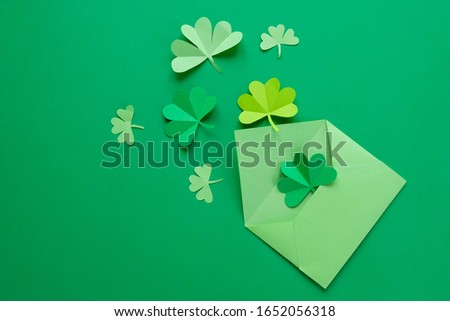 St. Patrick's day, clover on a green shiny background