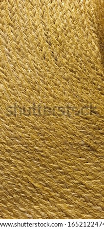 Gold bamboo hat pattern. Wovan straw hat texture. Background texture. Wallpaper. Vertical. Mobile photography. Natural product. Thailand.