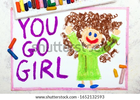 Photo of colorful drawing: Smiling young woman and hand drawn lettering phrase YOU GO GIRL
