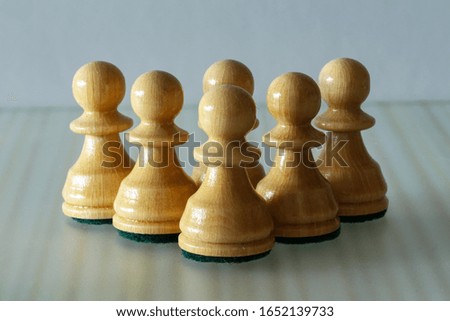 Pawn - chess pieces on a blurry light background