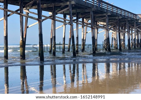 Scenic wooden pier reflections in the ocean
