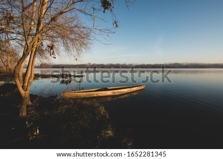 Boat resting on the lake in a foggy morning