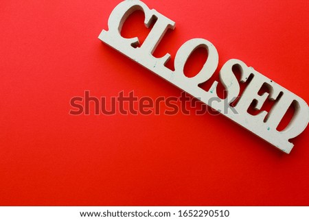 Wooden "closed" sign with red background. closed signs for businesses. wooden sign to inform people the shop is closed.