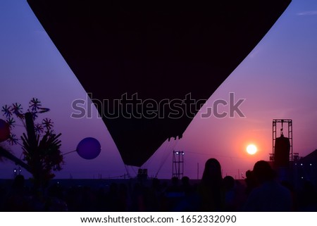 The beautiful silhouette Hot Air Balloon picture at the evening vibrant sunset under a colorful cloudy sky stock photo.