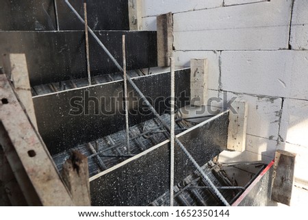 wooden formwork and steel bar ready for concrete stairs construction , working site background
