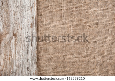 Burlap background bordered by old wood Royalty-Free Stock Photo #165239210