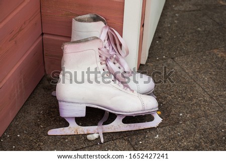 Old figure skates stand on the porch at the entrance to the house.