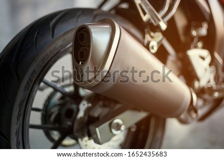 motorcycle exhaust with wheel side view