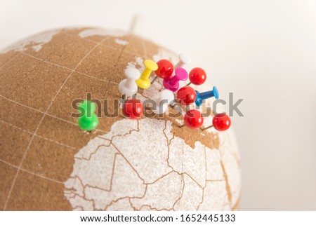 cork world ball showing the European region with colored pushpins · destinations · visited places · colored pushpins marking places, European