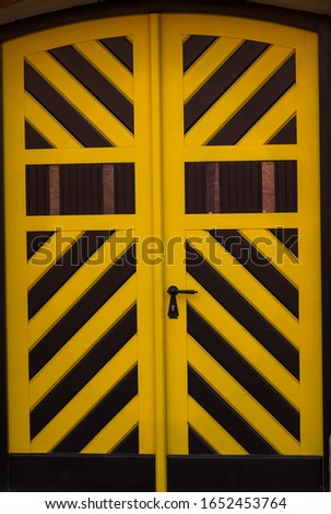 Antique yellow-black door with perfect symmetrical lines
