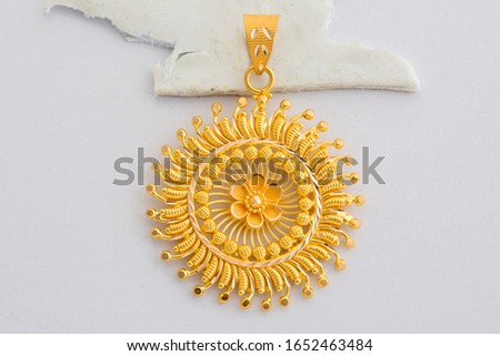Golden Sun Shape Pendent front view isolated in white background Royalty-Free Stock Photo #1652463484