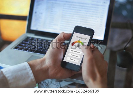 credit score concept on the screen of smartphone, checking payment history and ranking in bank Royalty-Free Stock Photo #1652466139