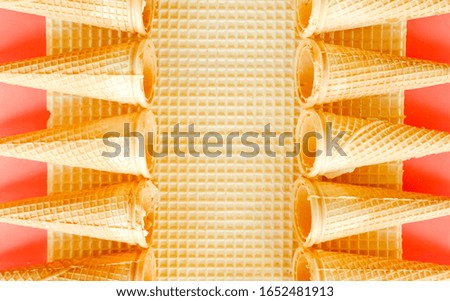 Empty ice cream cones on waffle and red background. Minimal food concept. 