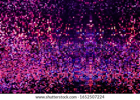 Disco wall background in neon led dot lighting, glitter effect, vibrant colorful pattern in pink and purple colours