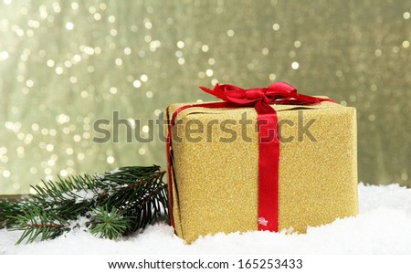 Beautiful bright gift and christmas tree, on shiny background