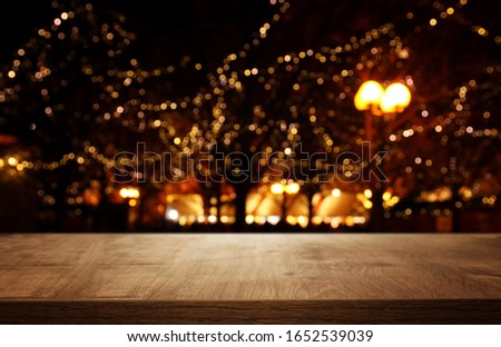 background Image of wooden table in front of street abstract blurred lights view
