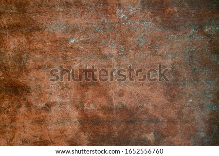 Texture of old wooden table with scratches and stains. Burgundy vintage background.