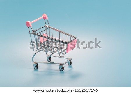Shopping cart over blue green background