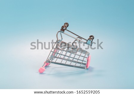 Shopping cart over blue green background