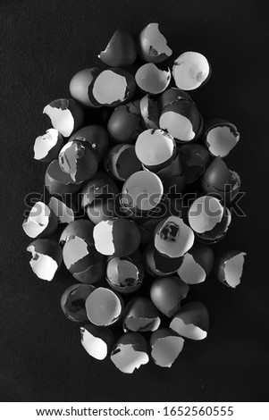 Easter. Black and white photo. Easter and Lent concept. A pile of fragments of eggshells on a black background.