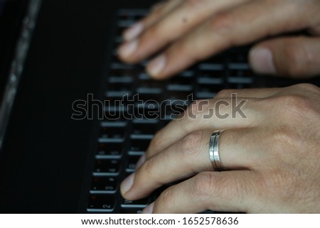mans hand and black computer 