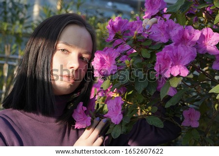 portrait of young woman in garden, face close-up