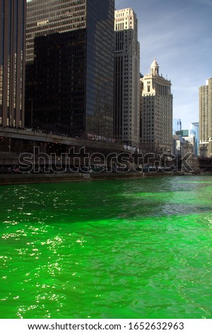 Chicago River Dyed Green Saint Patrick's Day with buildings along the shoreline