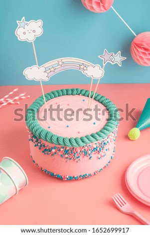Birthday cake for boys and girls with glasses and paper straws for a party