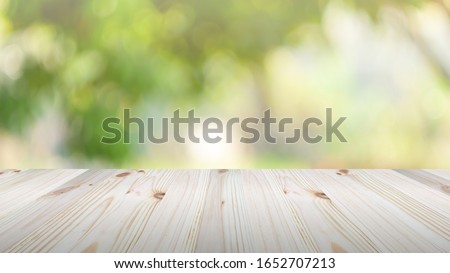 Wooden table top on green nature background