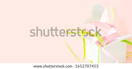 Flower banner. Composition of pink Origami paper tulip with green decorations in white box-heart on pink background. Copy space. Happy Women's Day, March 8, Mother's Day. Greeting card. DIY concept